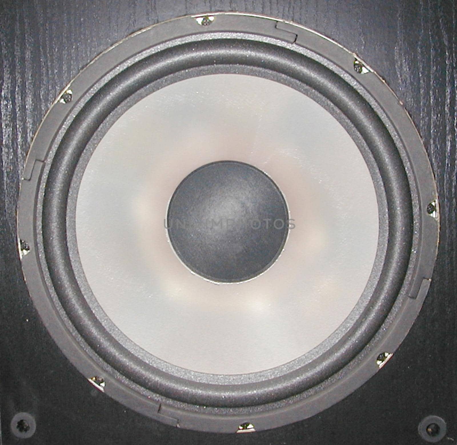 Circular speaker in a wooden box in a home audio system for personal entertainment