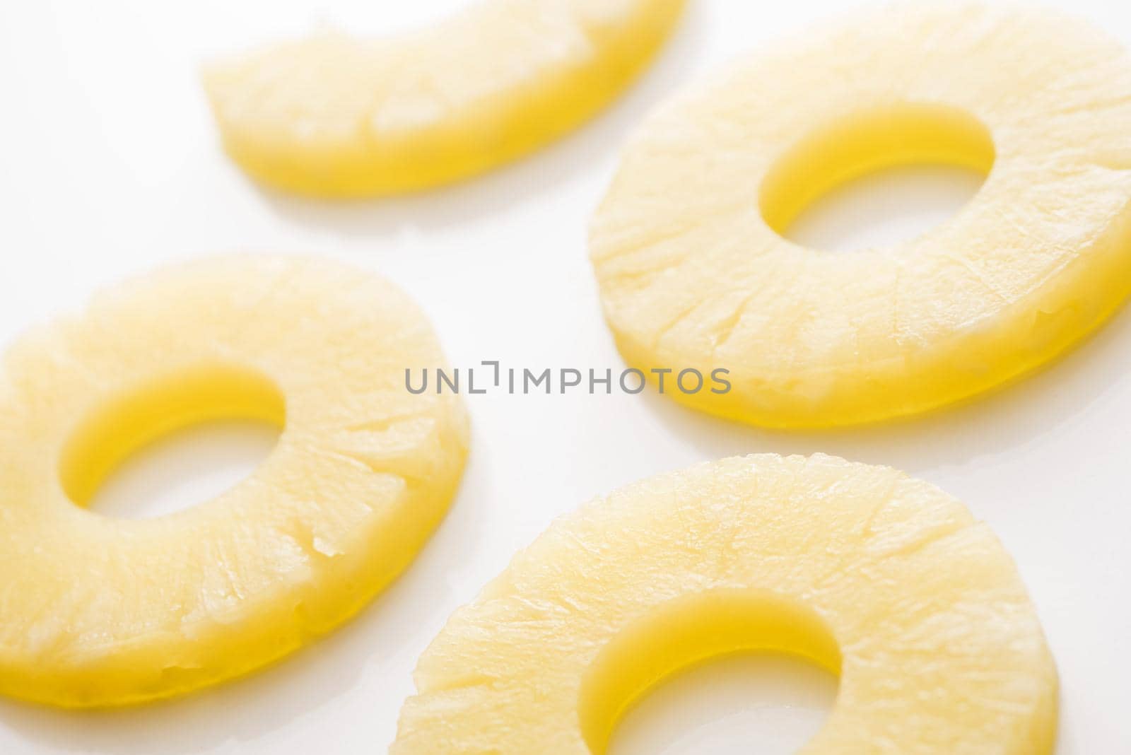 Close-up of pineapple cut in rings against white background