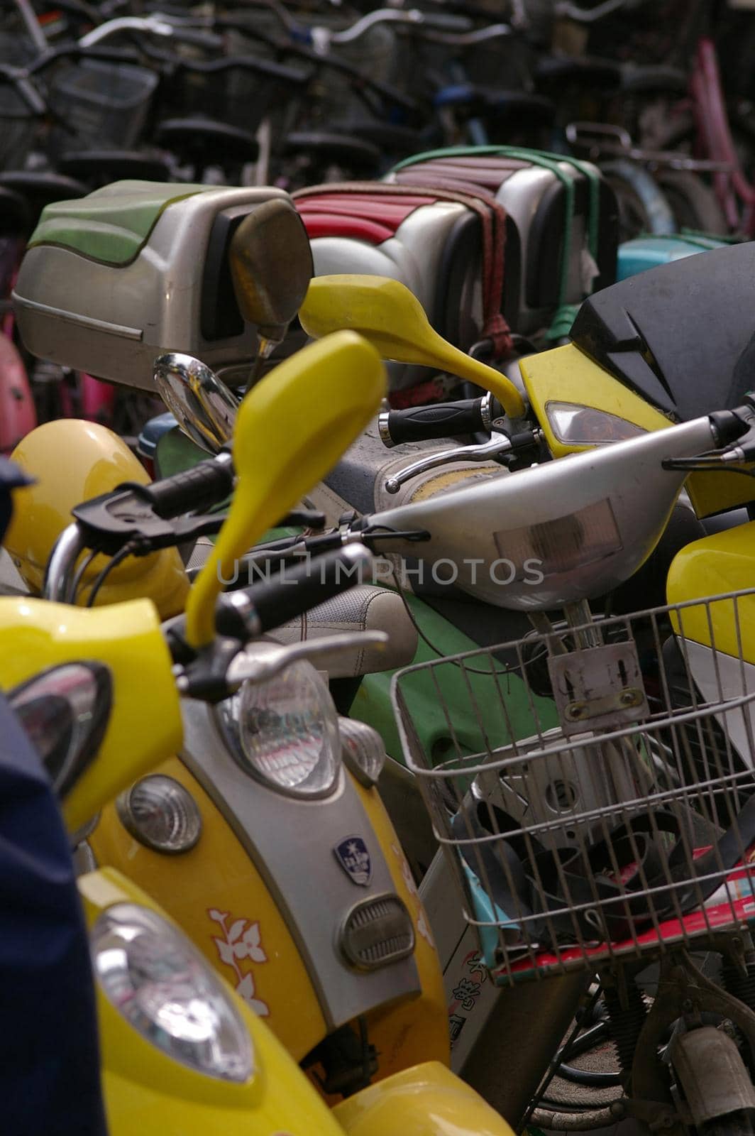 a row of scooters or mopeds parked on a street