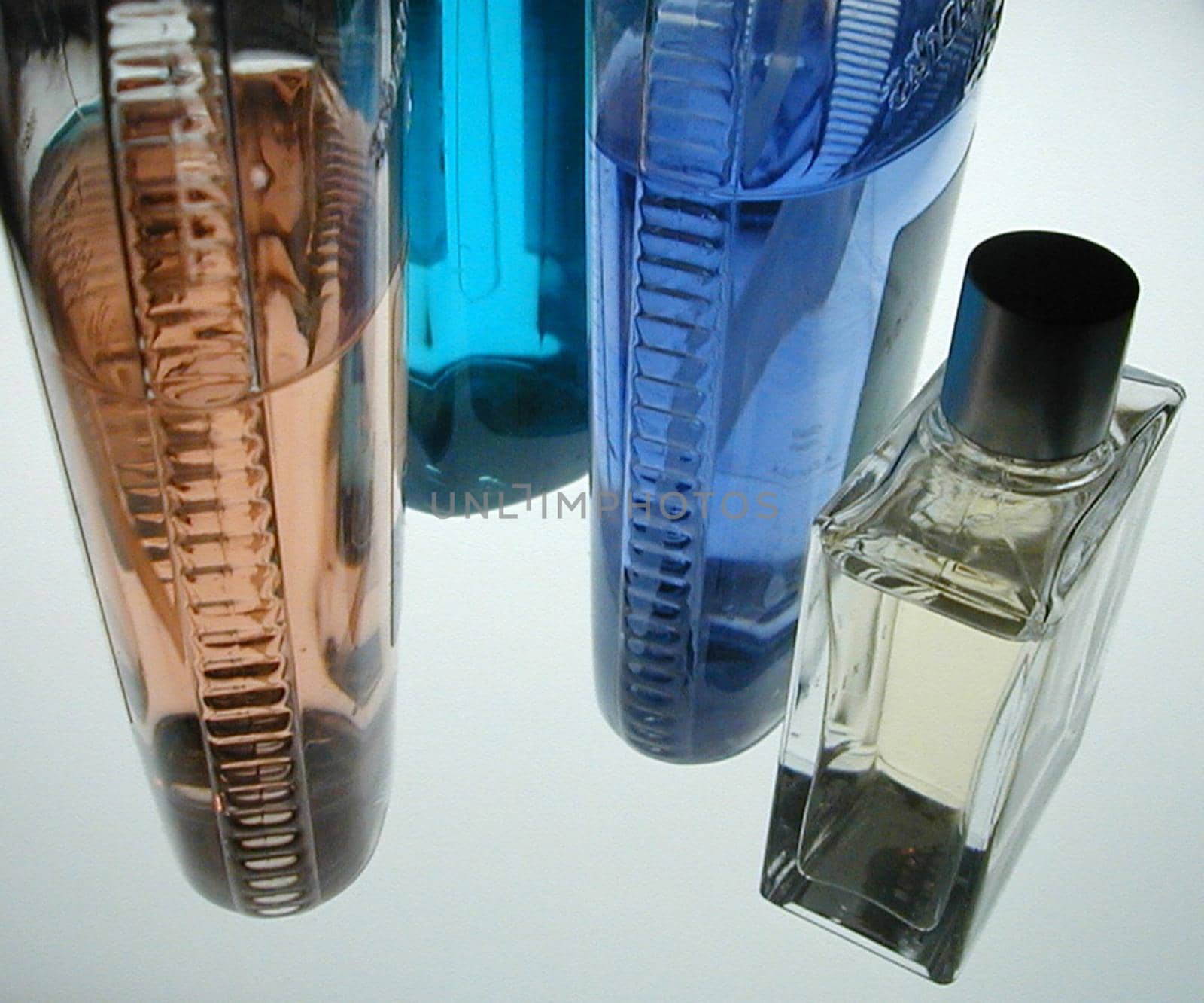 colorful bottles of after shave and other bathroom lotions