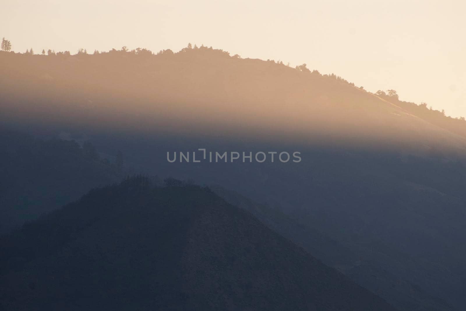 a beam of sunlight across the bigsur cliff landscape