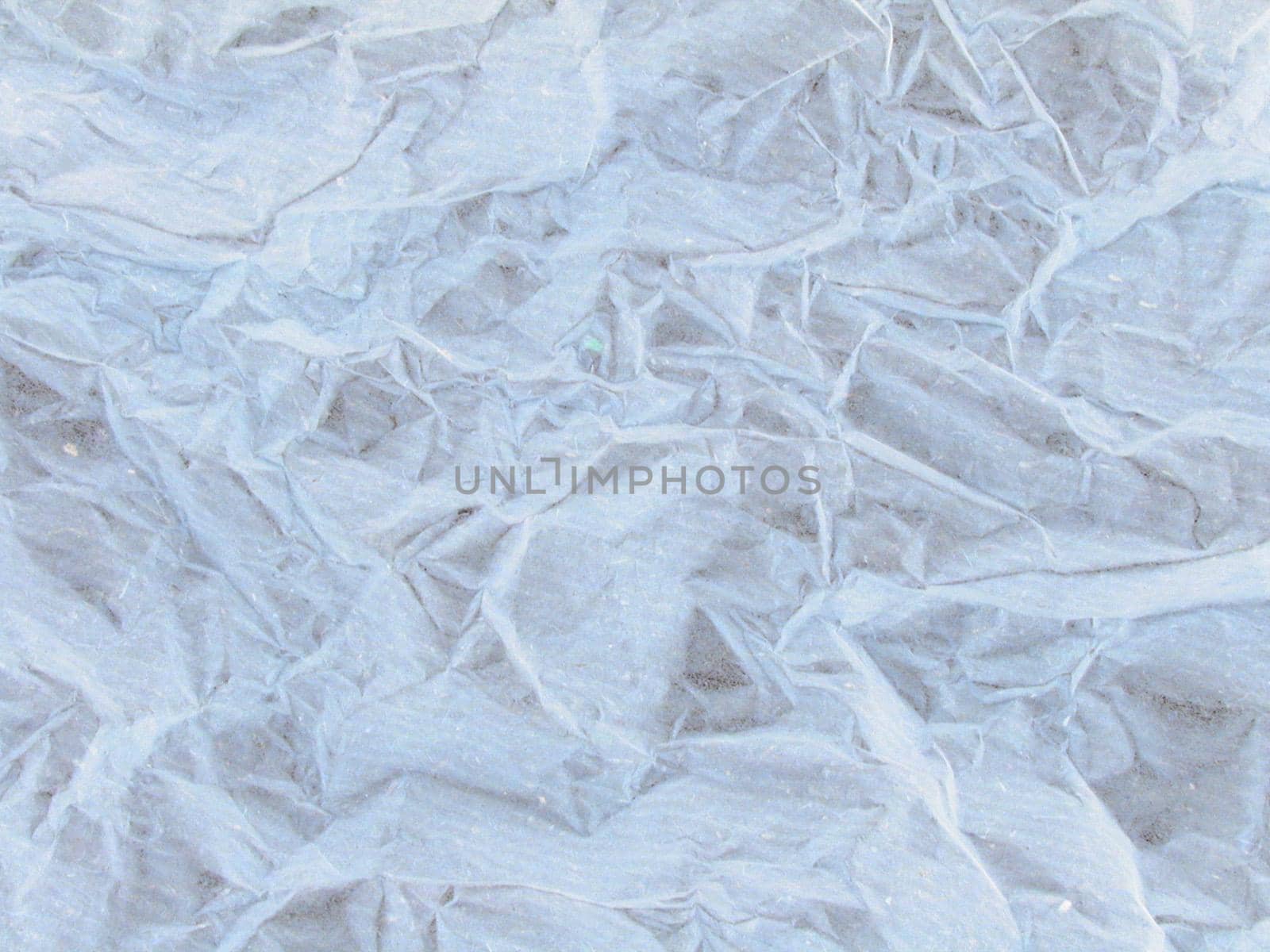 Detailed background of wrinkled paper in white neutral color with rough texture with copy space