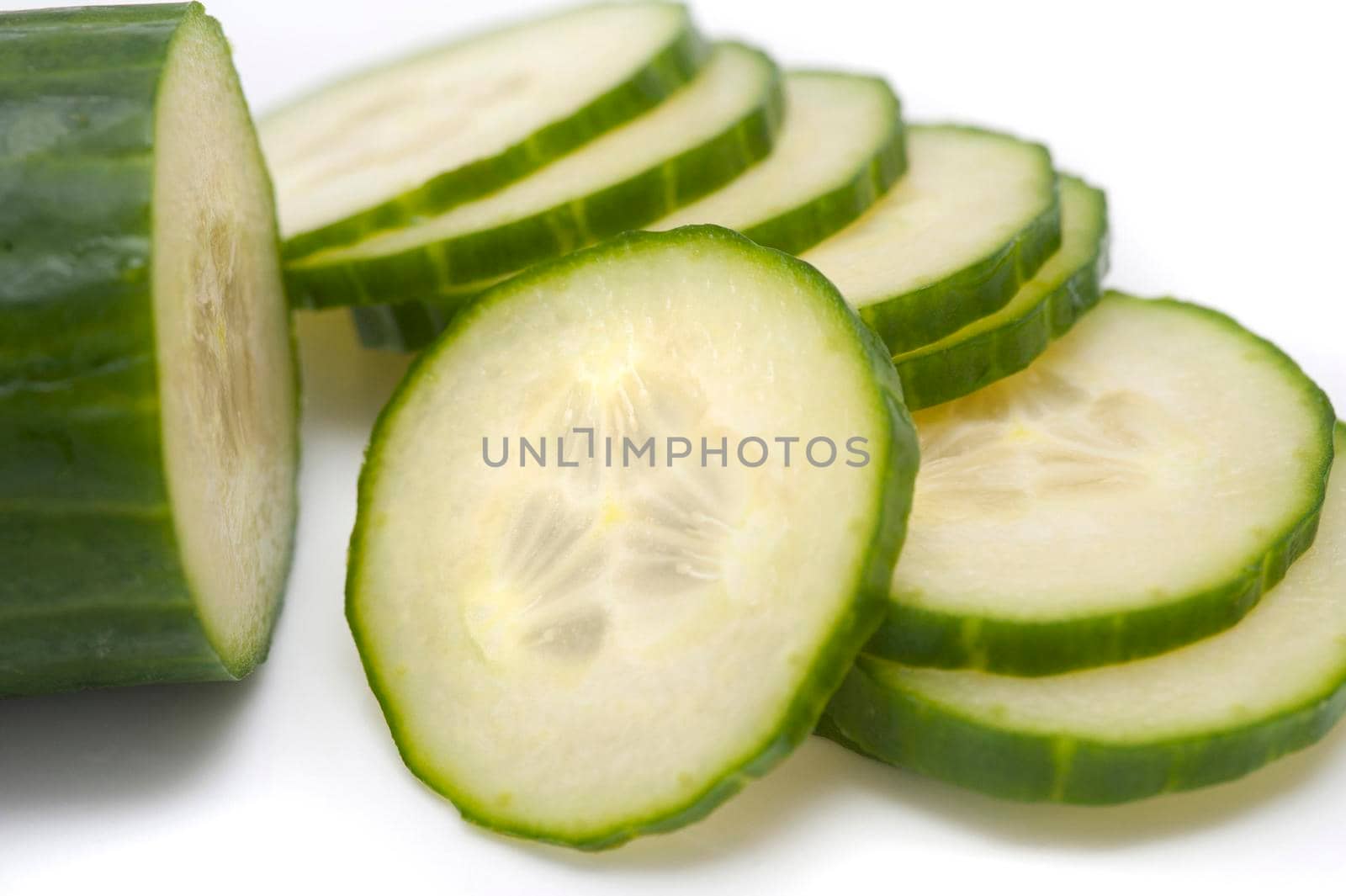 Thinly sliced cucumber being prepared as a salad ingredient showing the pips and flesh detail