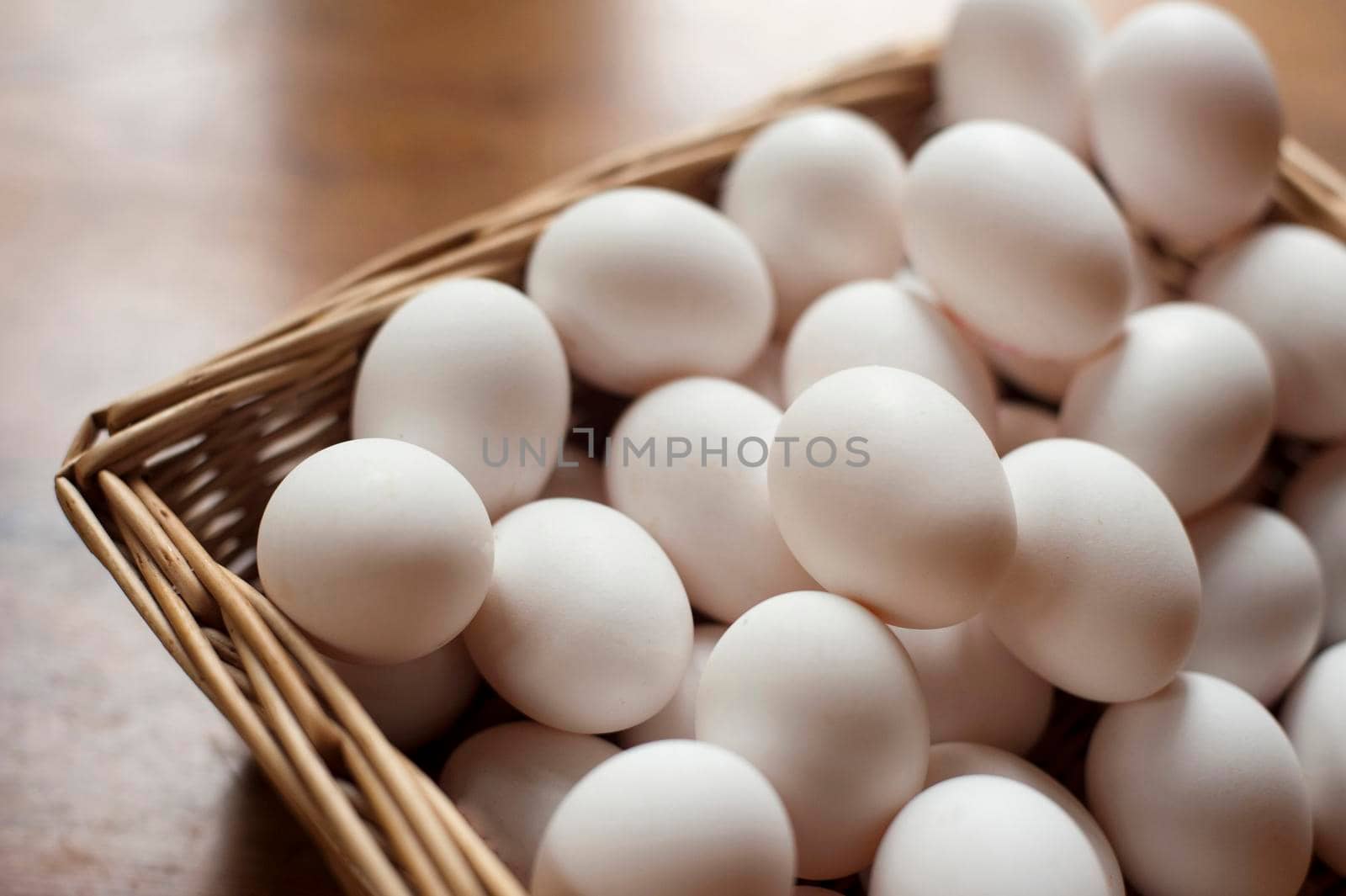 Farm fresh hens eggs in a wicker basket for sale at a farmers market
