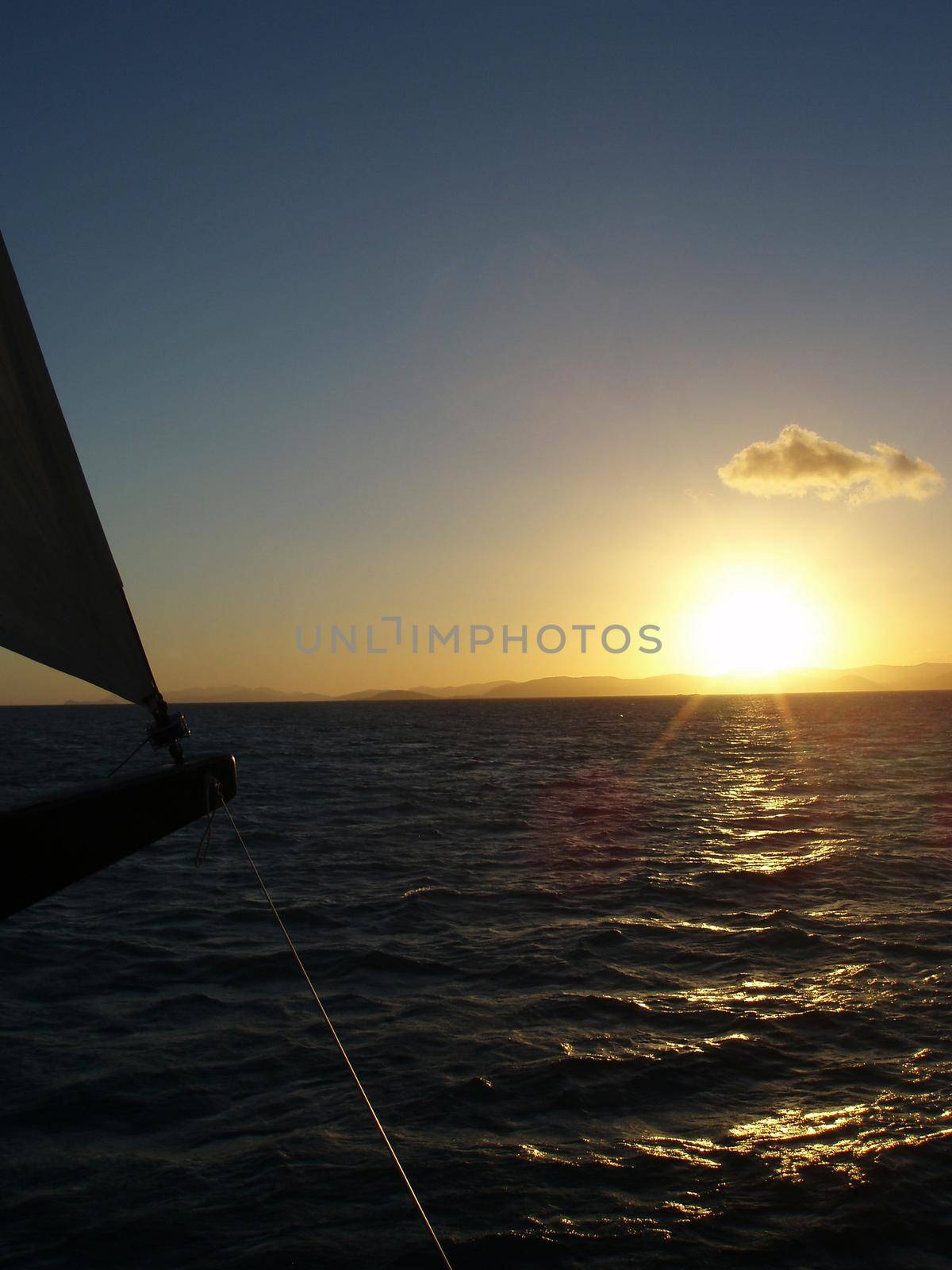 a sailing yacht at sunset, free to travel the globe with freedom