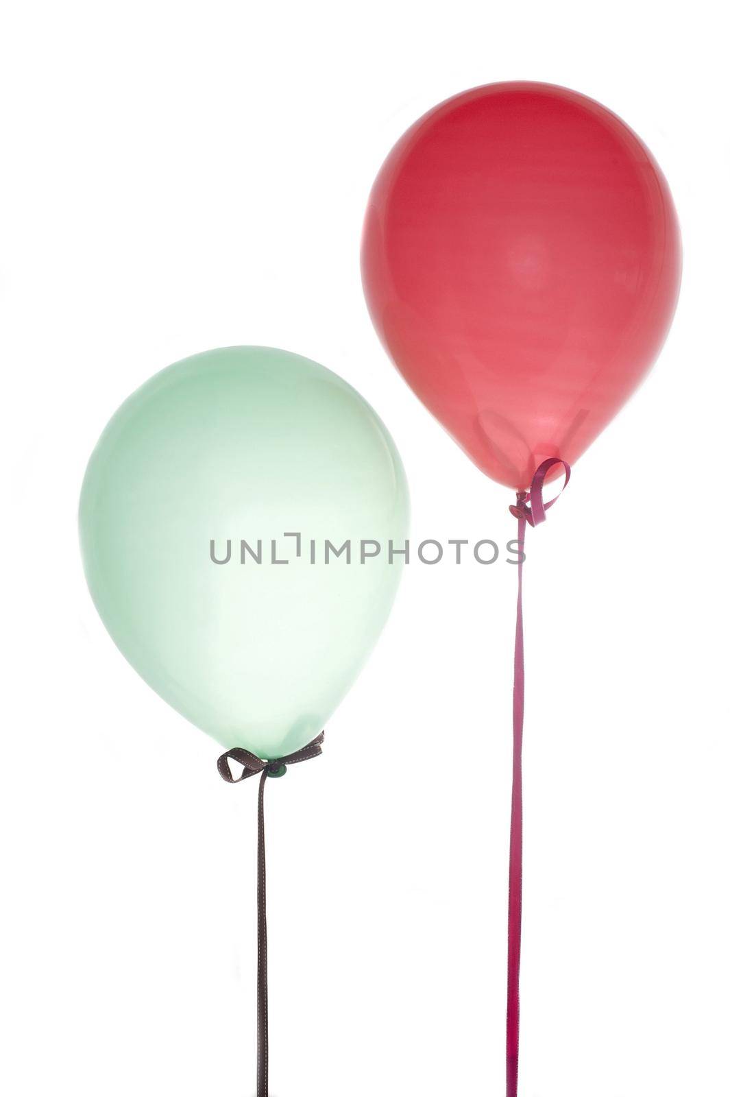 two floating ballons tied down with ribbons