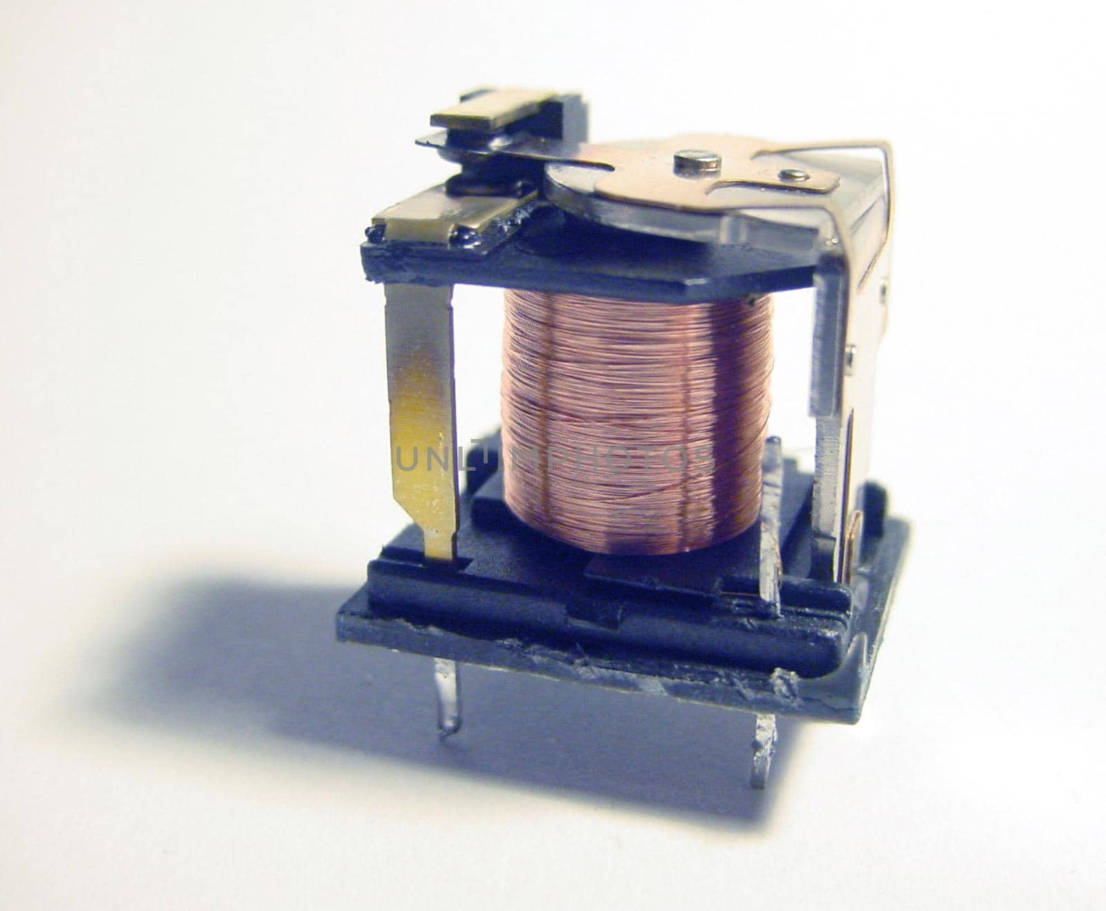 inside of an electromechanical relay switch showing coil winding and contacts