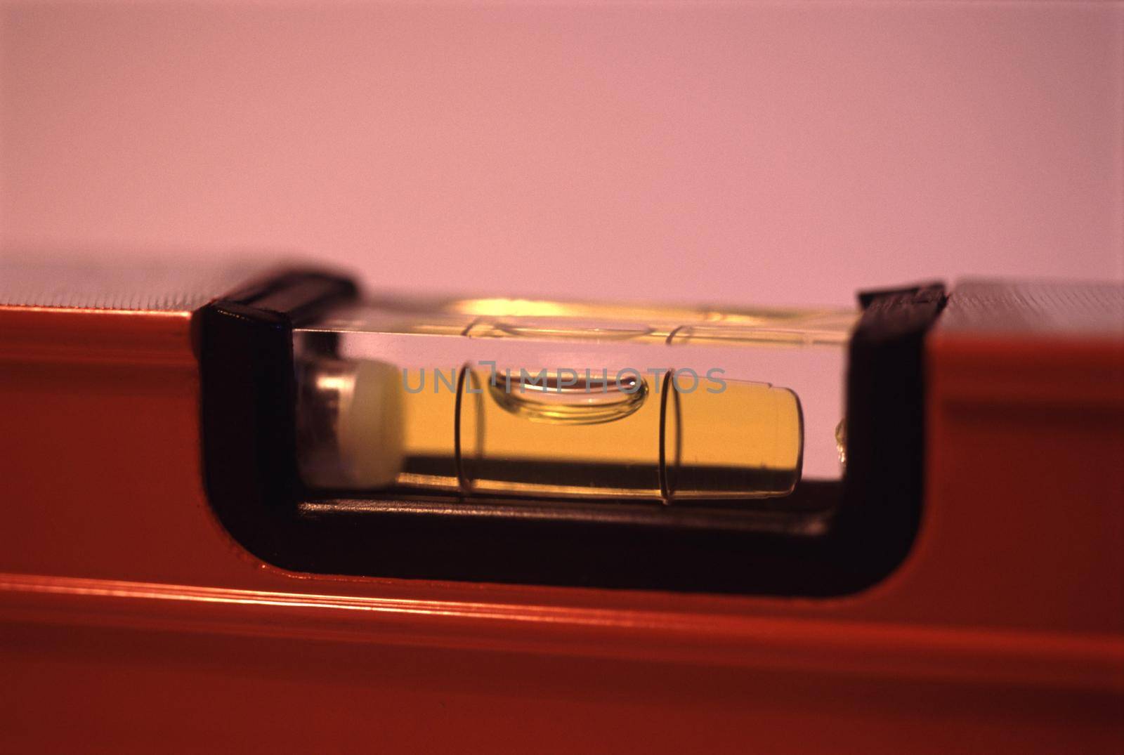 Close up on the bubble in a builders spirit level in a DIY, construction, maintenance, and renovation concept