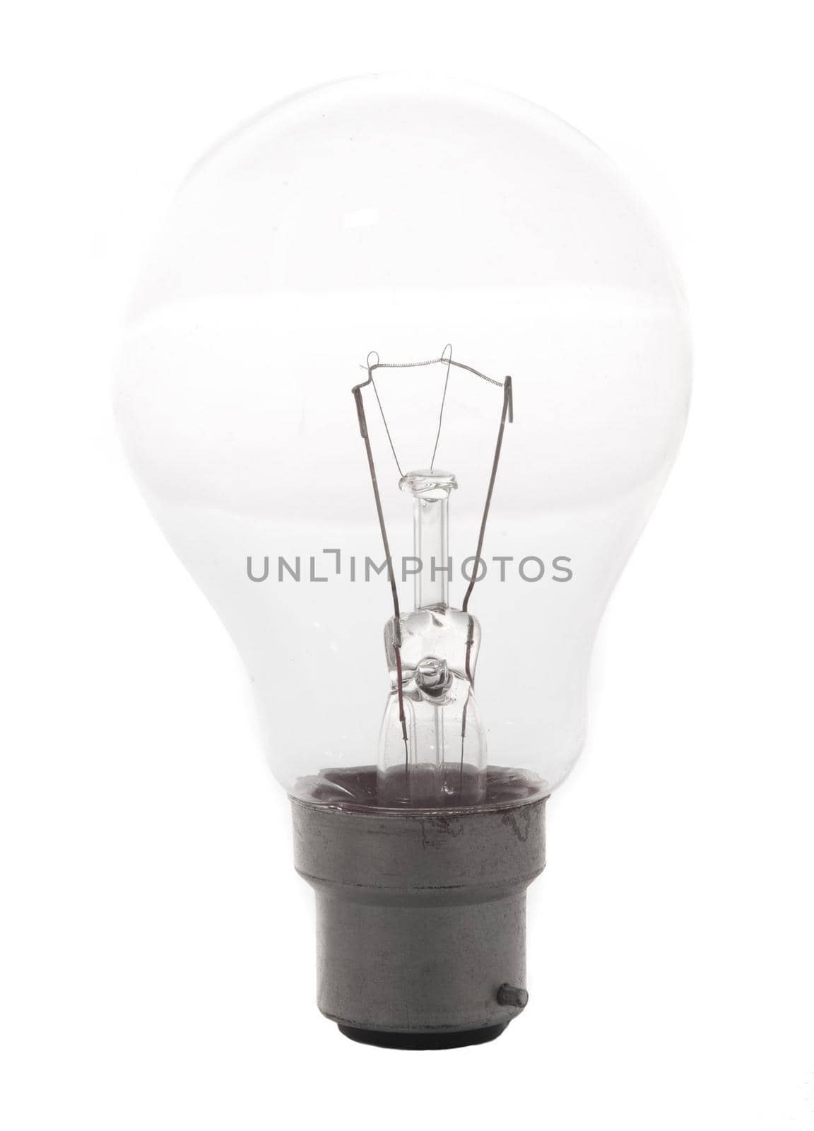 Traditional household glass incandescent light bulb on with bayonet fitting isolated on a white background in a power and energy concept
