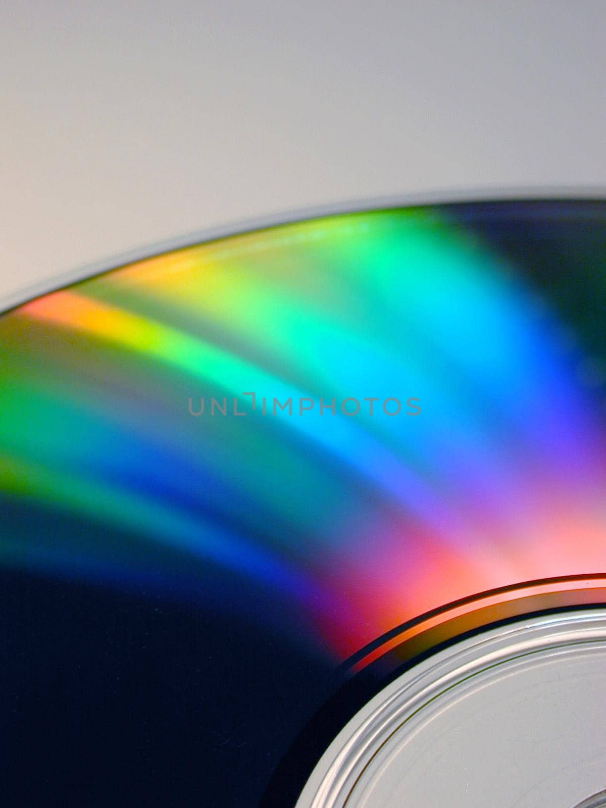 Bright colorful iridescent refraction of light on a DVD or CD in the colors of the spectrum or rainbow in a close up view
