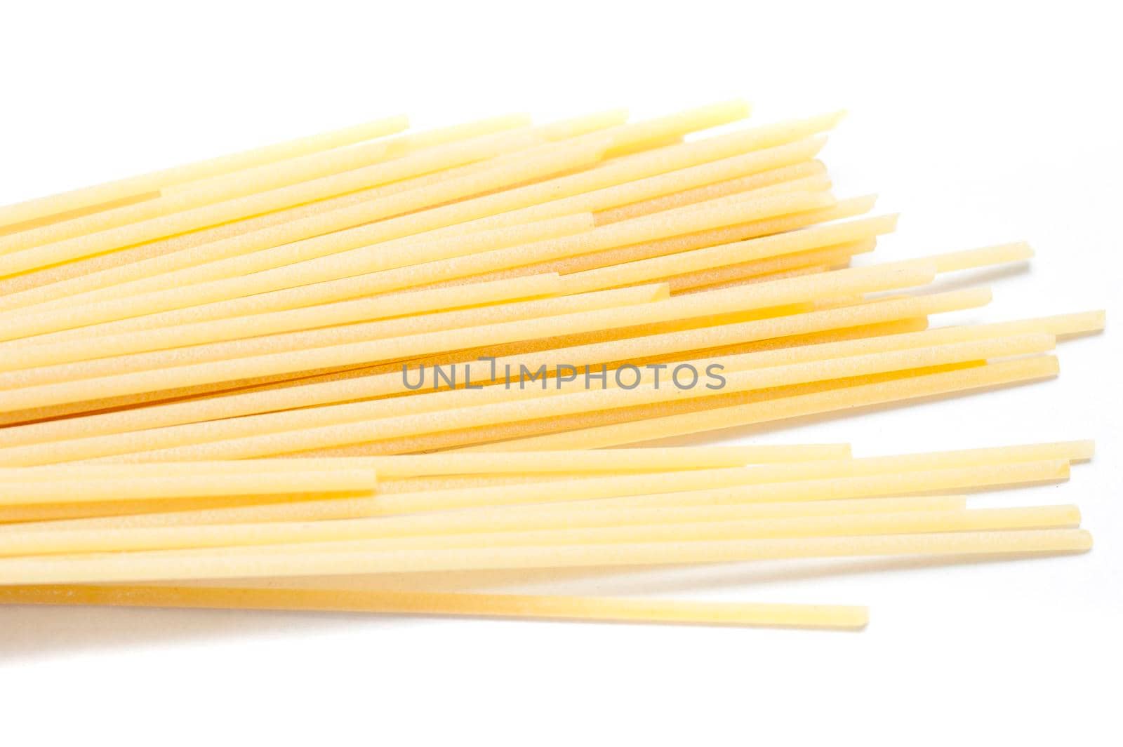 Uncooked Italian spaghetti pasta made from healthy durum wheat and used as an ingredient in Mediterranean cuisine