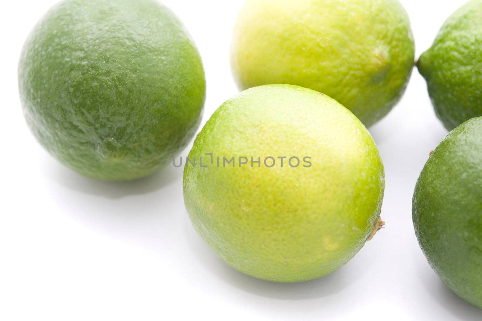 Fresh whole limes, an acidic citrus fruit with a tangy taste used as a flavouring in cooking and as a garnish