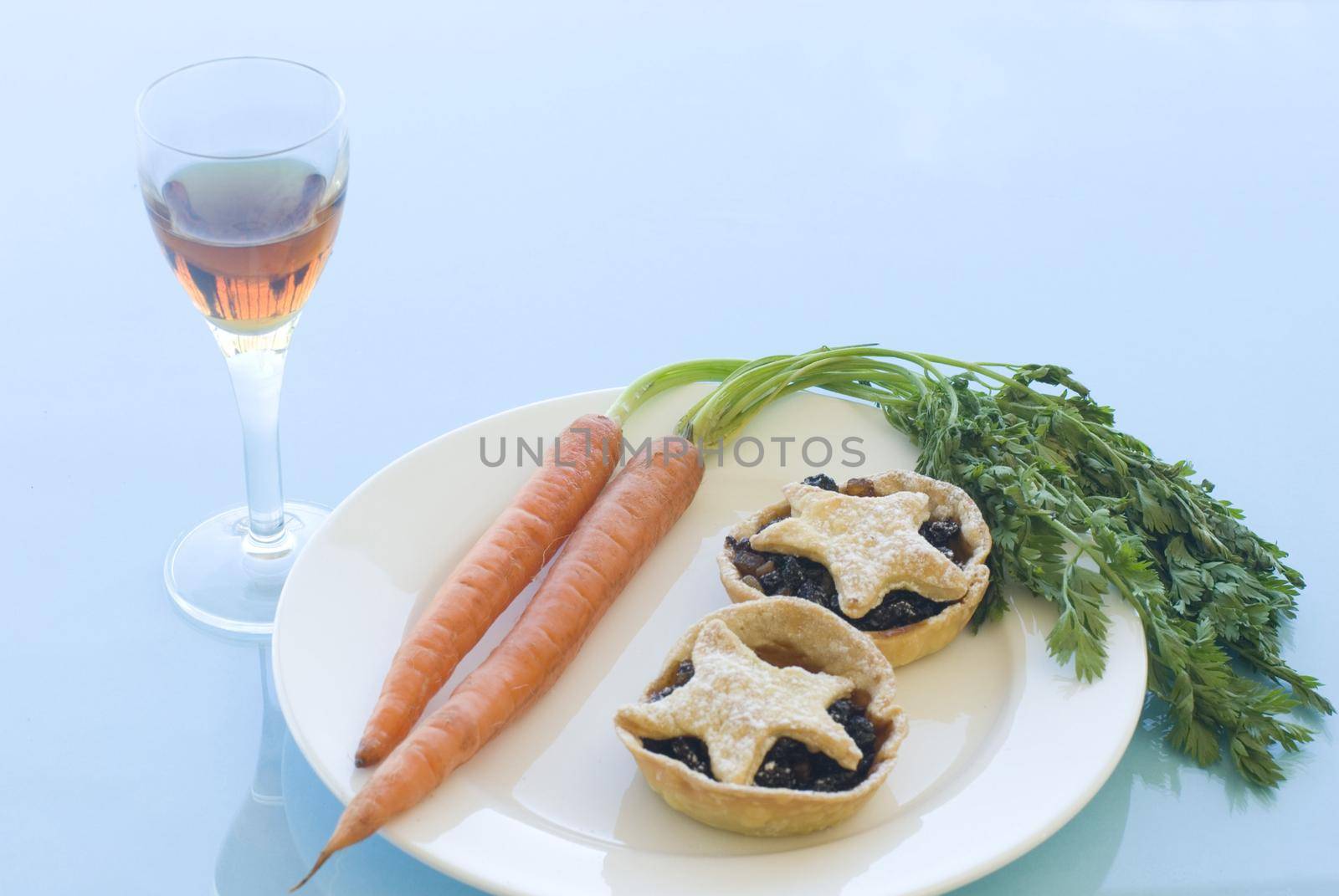 a plate of christmas mince pies for santa and carrots of rudolph