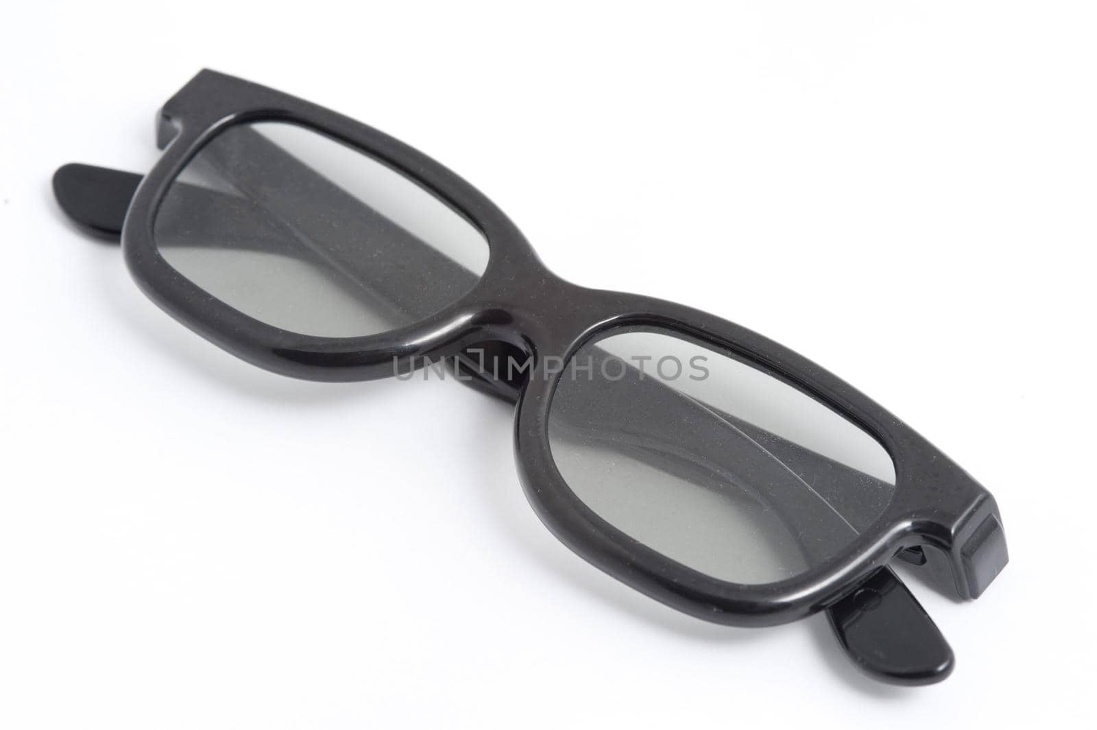 A pair of polarizing 3D movie spectacles on a white background