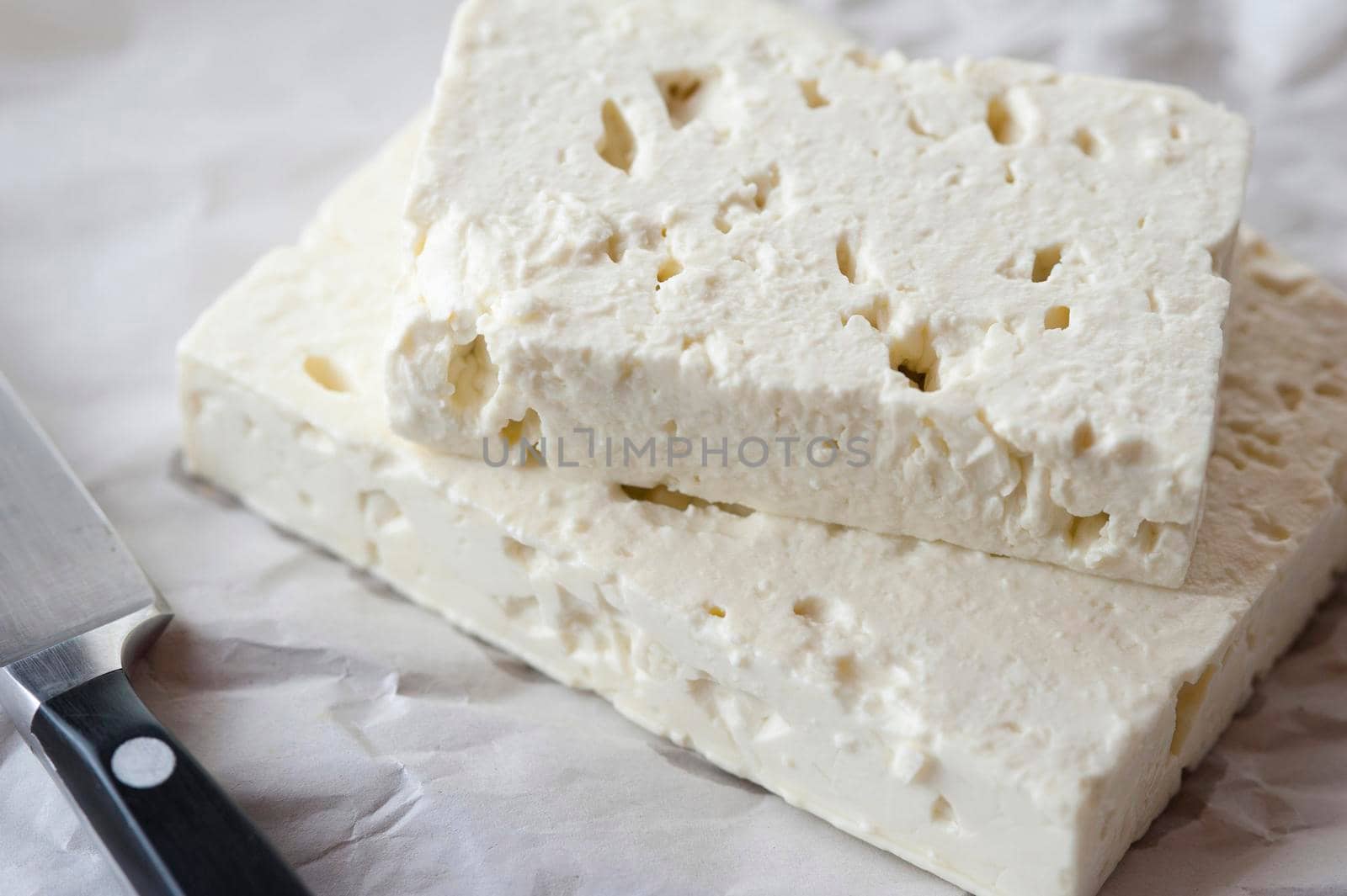 Closeup view of two slabs of feta goats milk cheese for use as a delicious salad ingredient or in cooking