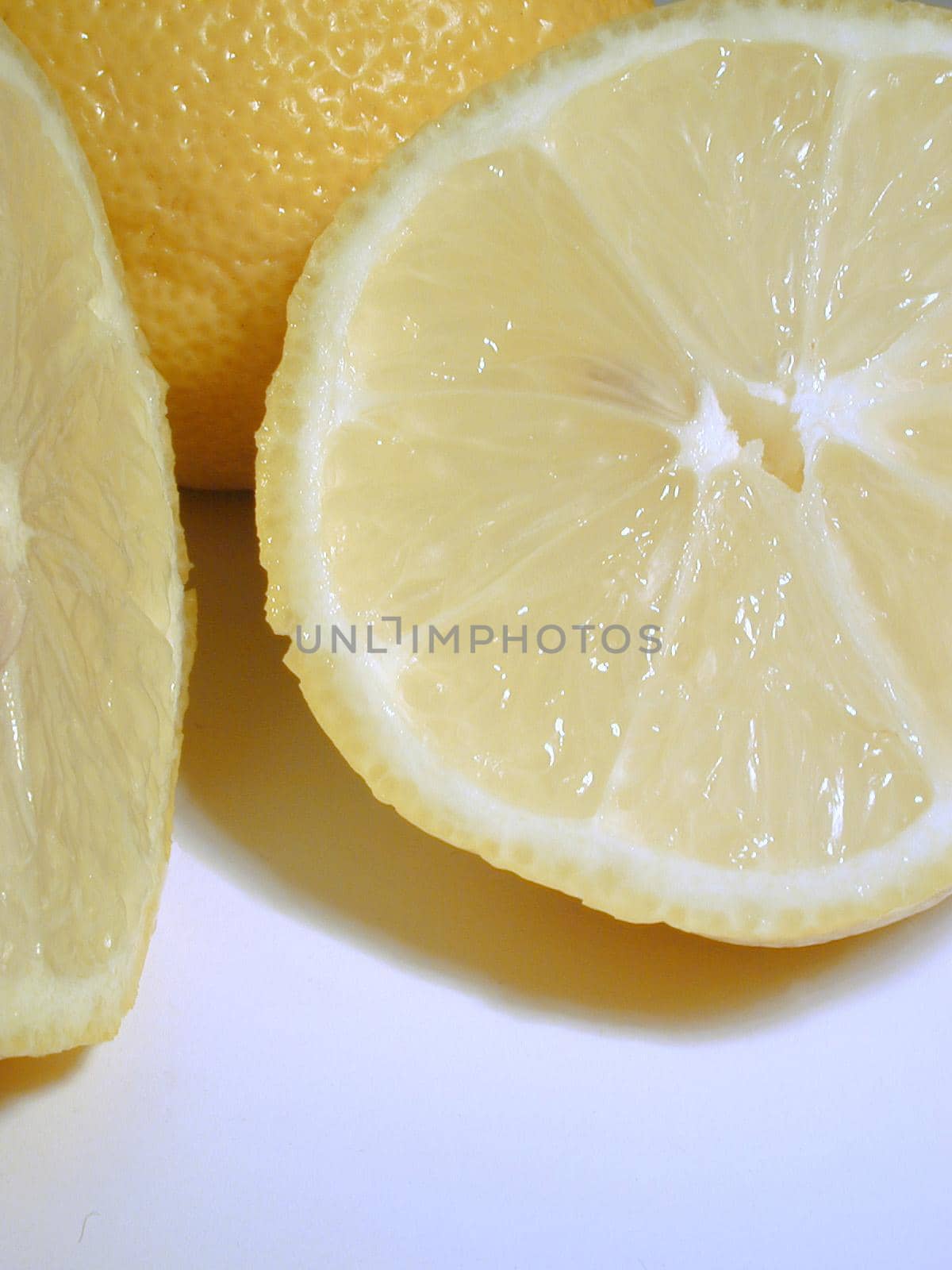 Sliced tangy fresh lemon rich in vitamin c used as a garnish and cooking ingredient for its sour taste