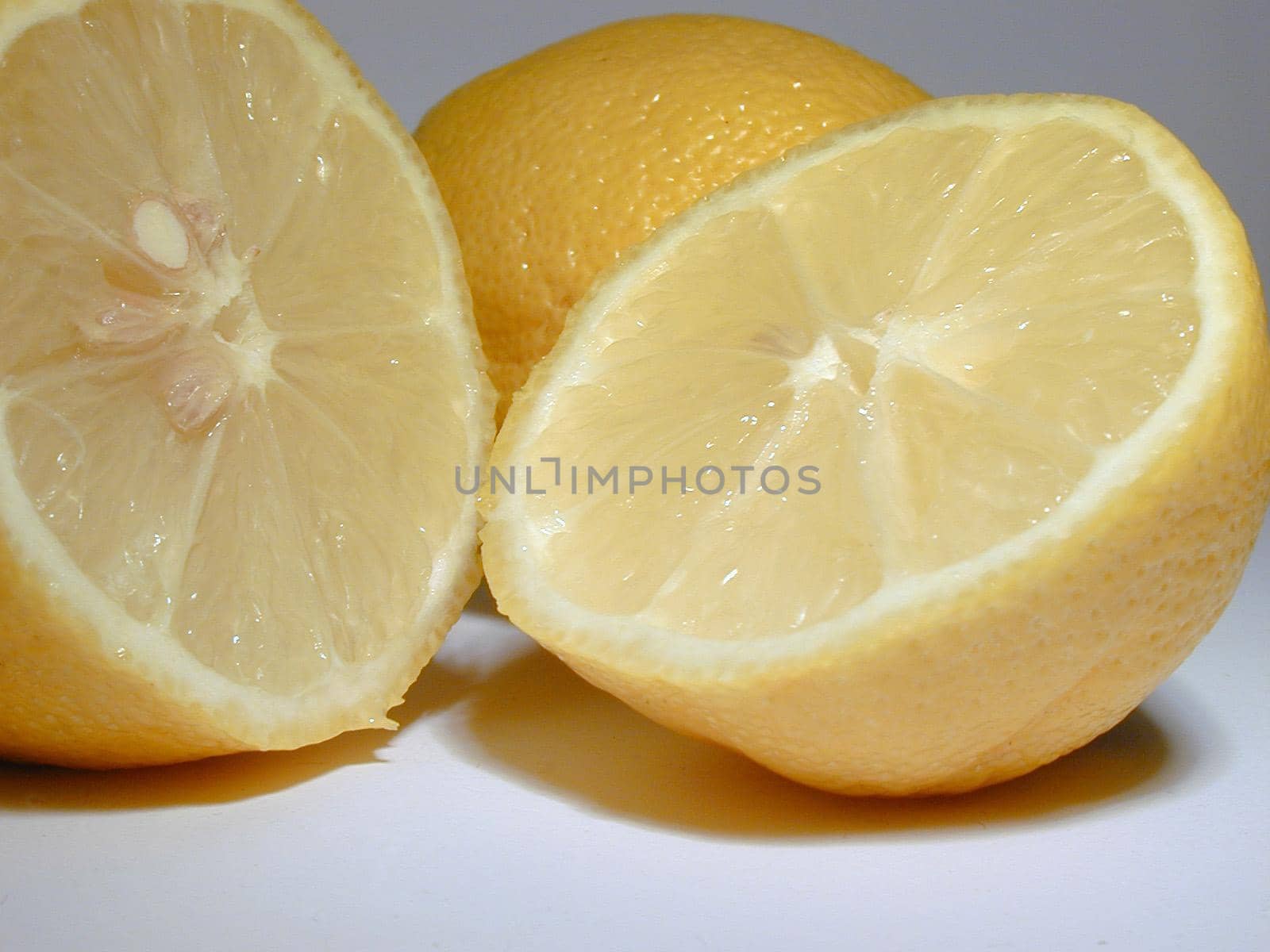 Halved fresh juicy tangy lemon rich in vitamin c used as a garnish, salad dressing and aromatic acidic cooking ingredient