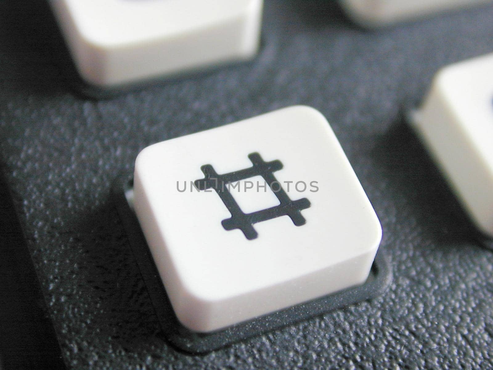Hash button on a mobile phone keypad with a number sign or pound sign icon, sometimes referred to as the hashtag