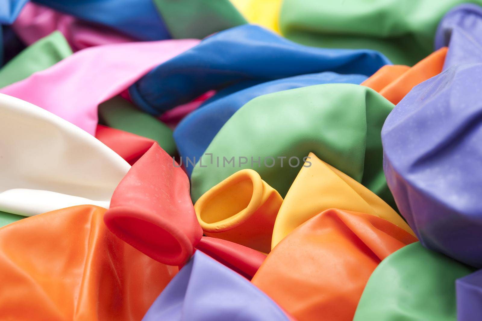 a pile of un-inflated rubber balloons