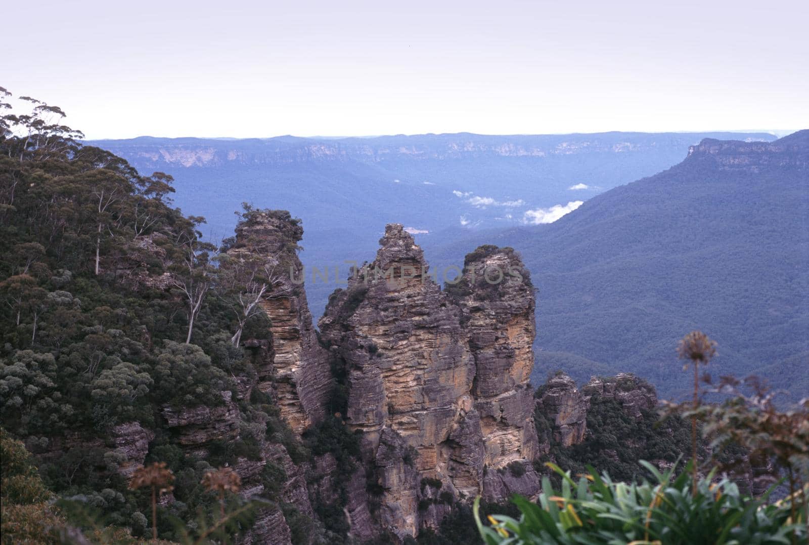 Scenic landscape view from a viewing point of the Three sisters rock formation, NSW, Australia overlooking distant valleys veiled in mist or haze