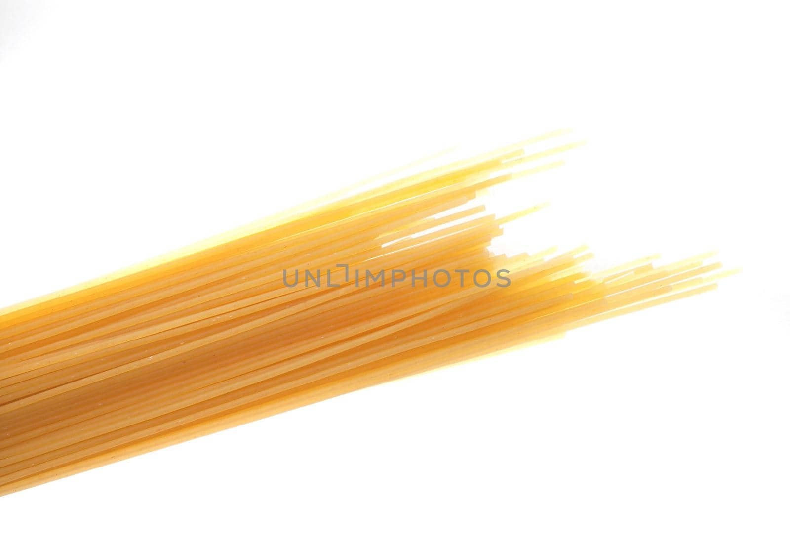 Bundle of uncooked dried Italian spaghetti pasta made from durum wheat dough as an ingredient in Mediterranean cuisine isolated on white