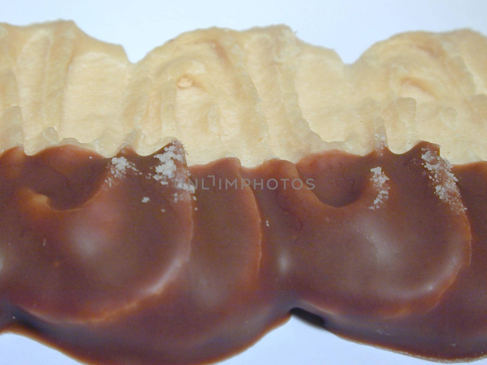 Close-Up of Chocolate Dipped Pastry Dessert on White Background