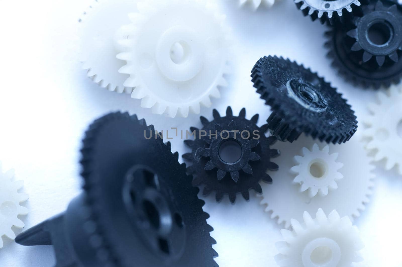Close up Black and White Gears on White Table for an Unorganized Concept