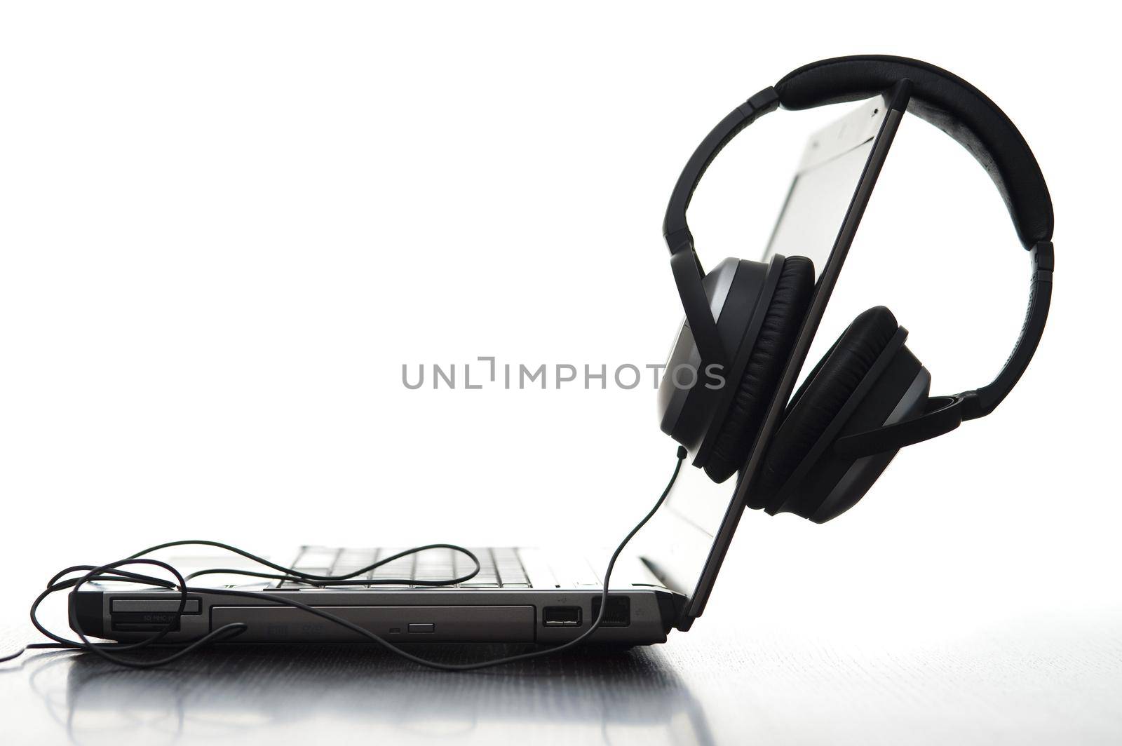 sideview of a laptop computer and hifi headphones