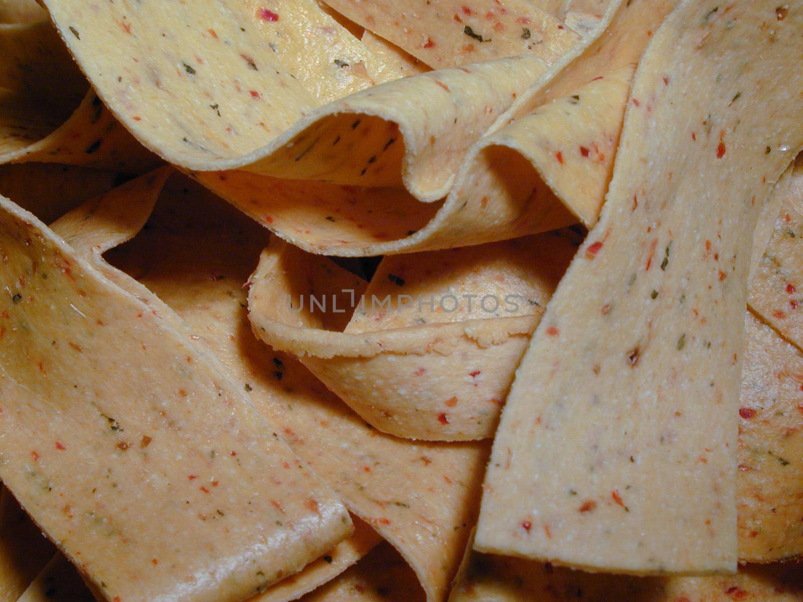Ribbons of seasoned pasta with tomato and herbs in a cooking, catering or food background texture