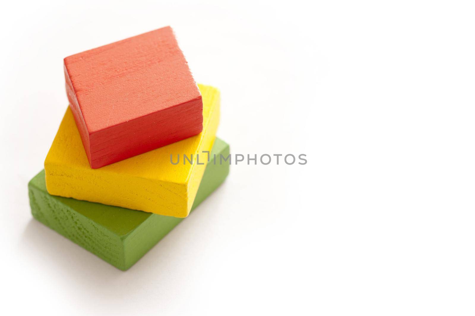 Small stack of colored blocks on white by sanisra