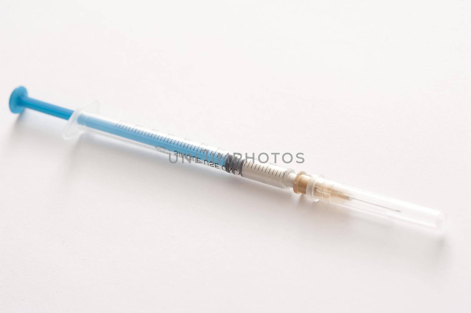 Small disposable plastic hypodermic syringe and injection needle for administering subcutaneous or intramuscular drugs