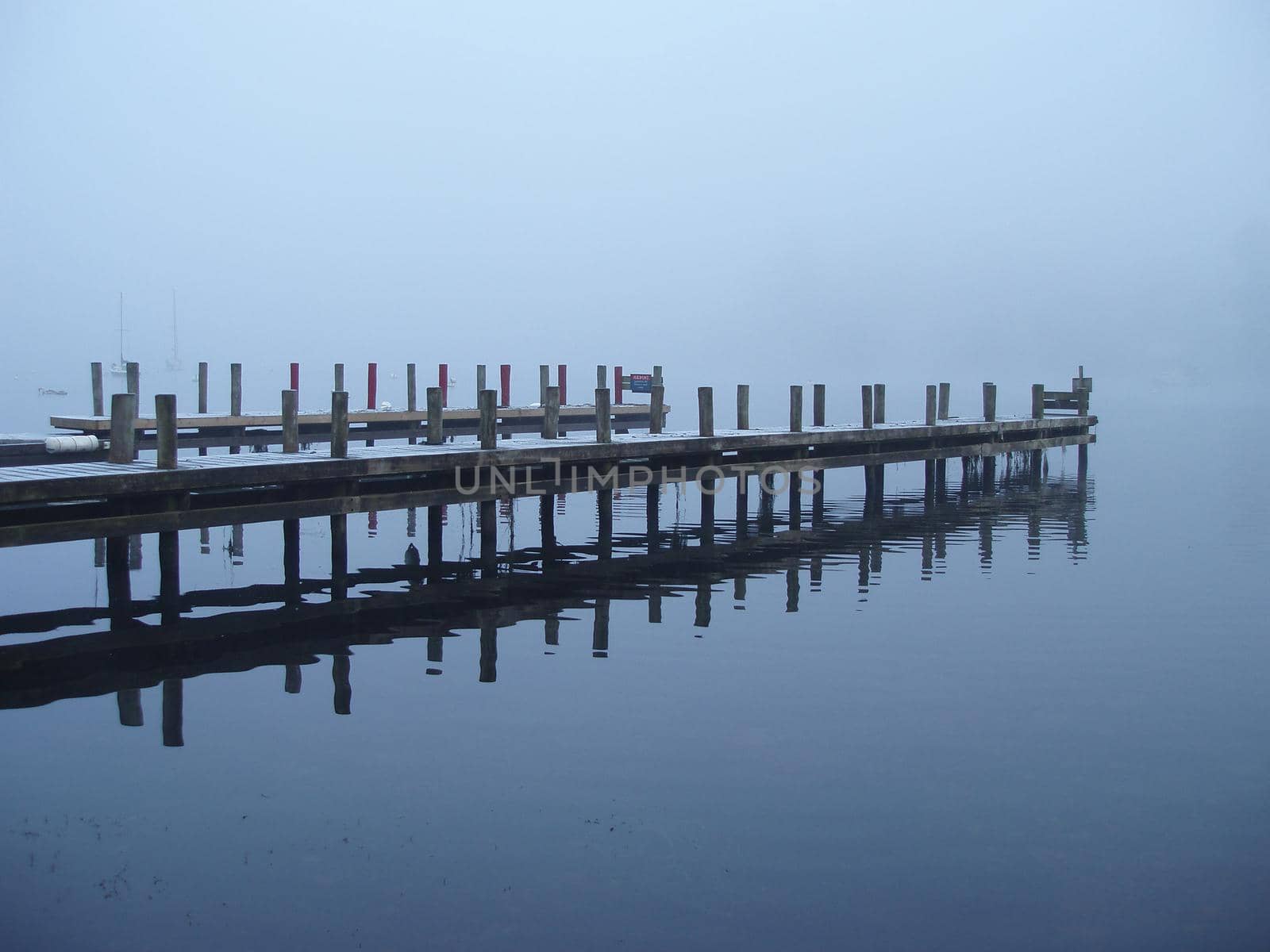 a jetty at fell foot on lake windermere on a misty day