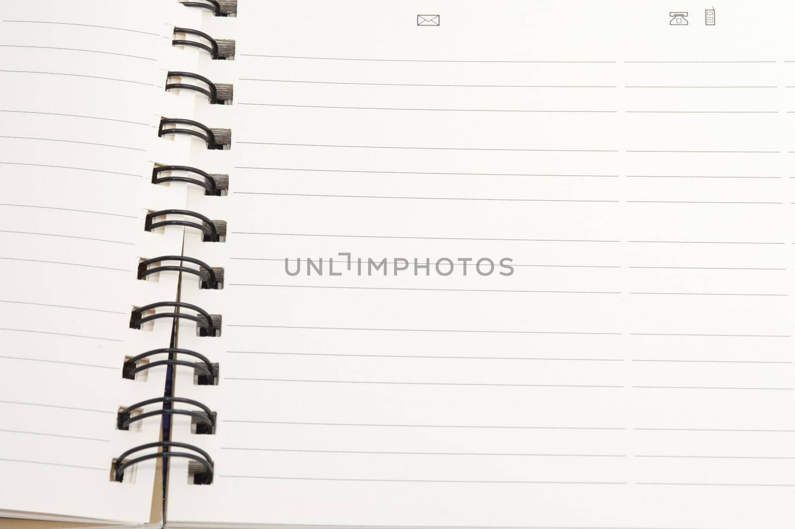 Open blank spiral bound notebook with lined pages ready for your text or message
