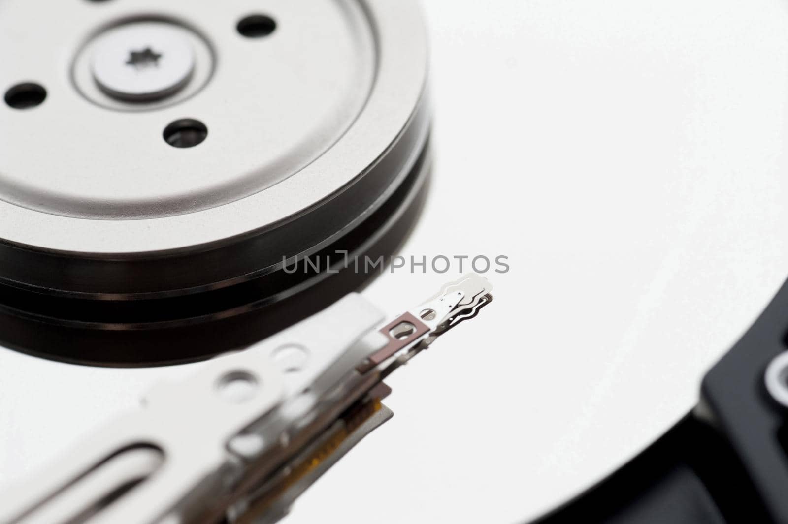 Abstract close up of a computer data storage hard drive and electrical components.