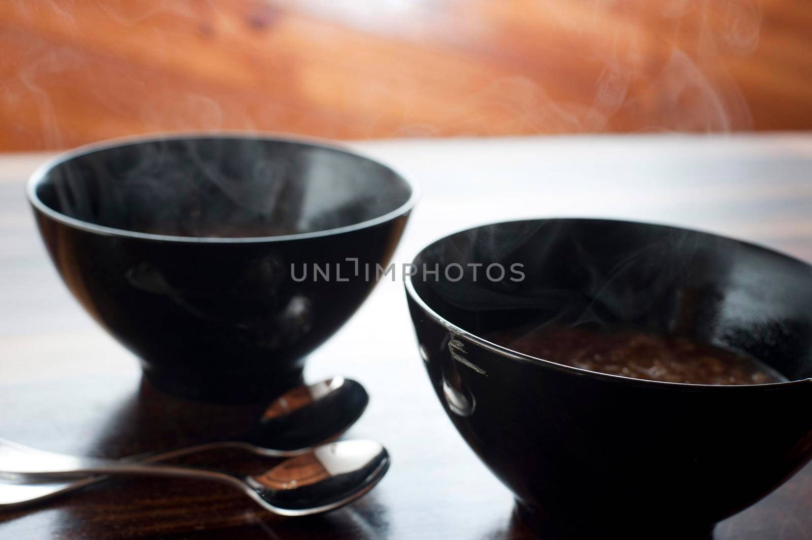 Two bowls of steaming hot onion soup for a tasty starter to a winter meal on a cold day