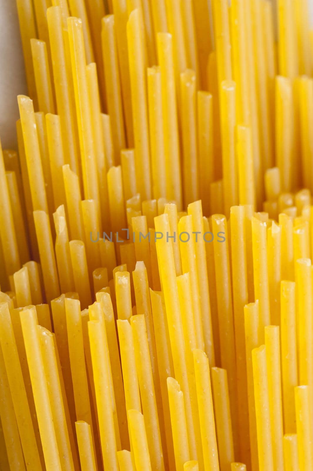 A background uncooked dry spaghetti