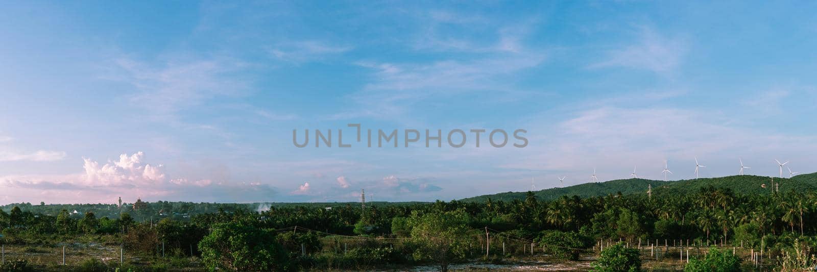 BANNER long format crop it, panorama summer landscape clouds buddhist temple statue windmills blue Sky Meditation background.