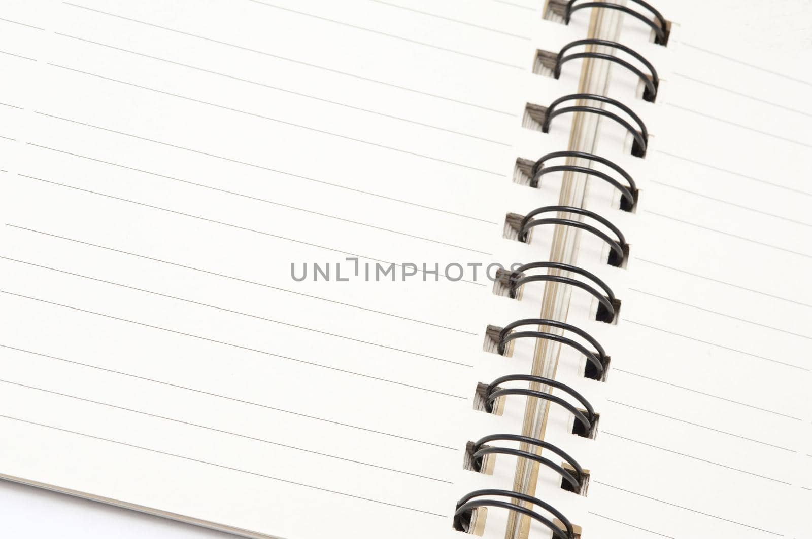 Open ringbound notepad with a blank lined page for your text or message