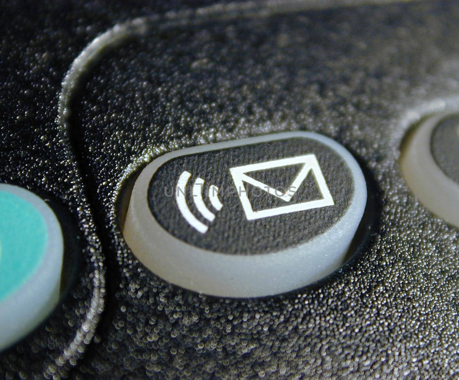 Voice mail sound alert button with envelope icon on a keypad in a close up view
