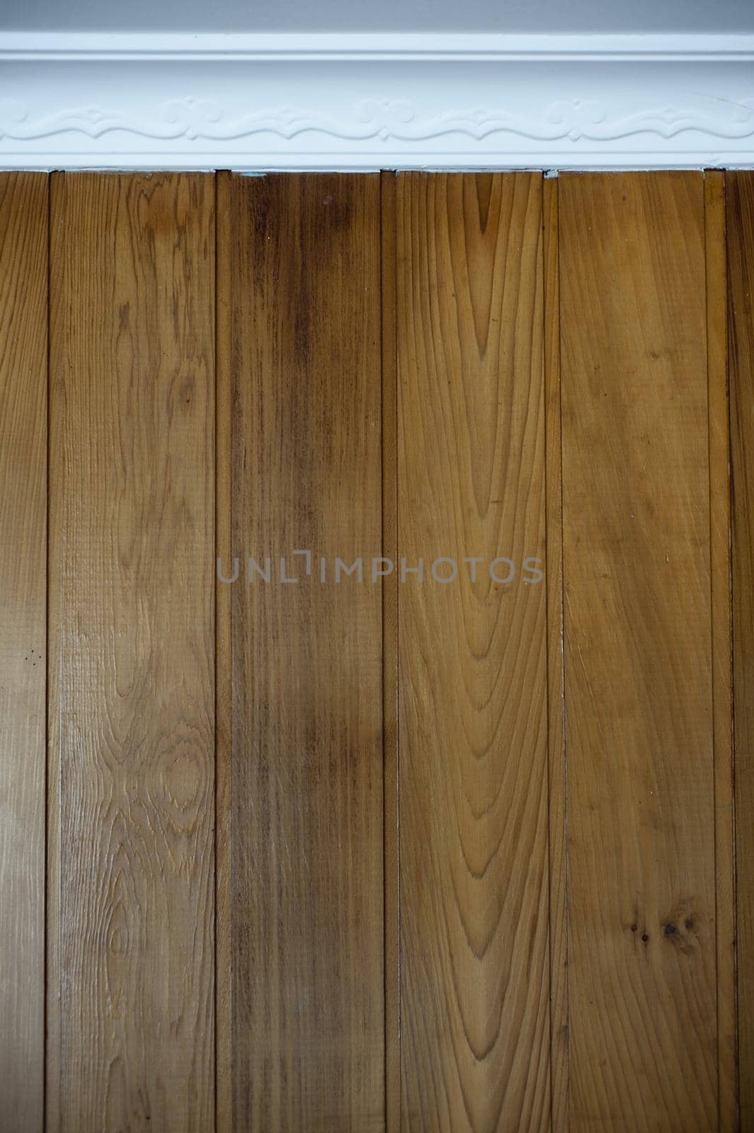 Close Up of Architectural Decor Detail Laminate Wood Wall Paneling and Decorative White Window Frame Border
