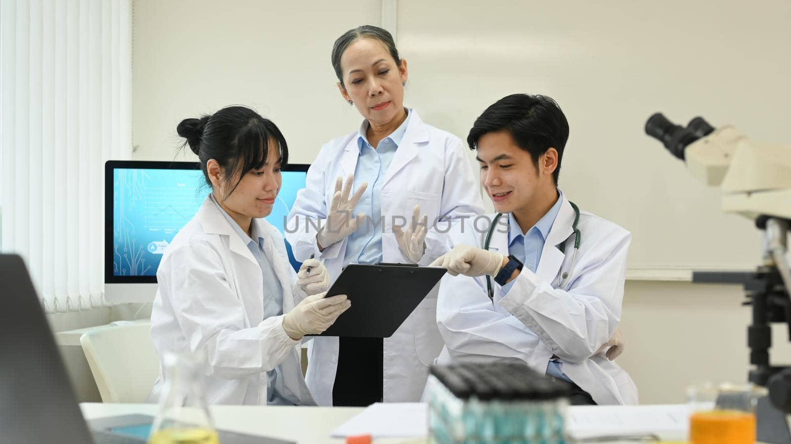 Professional scientist team conducting experiment in laboratory. Medicine and science research concepts.