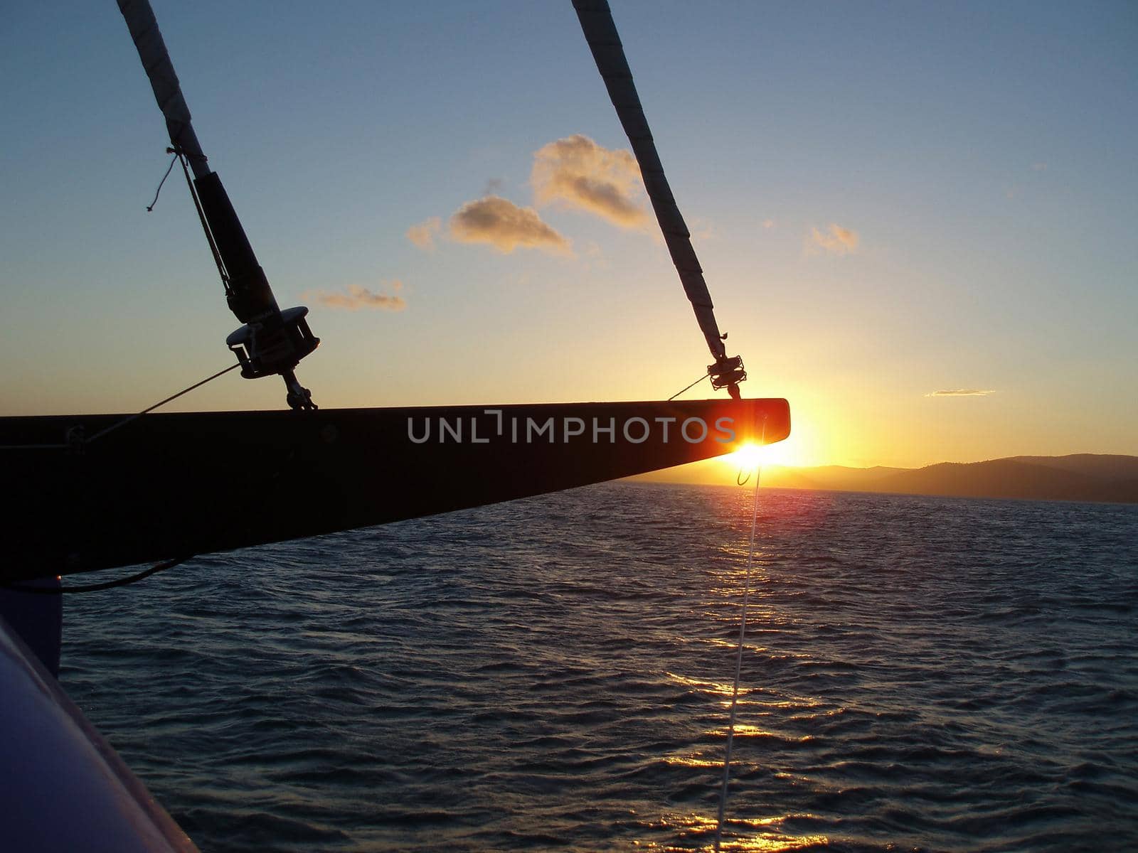 a relaxing way to travel, sailing on a yacht at sunset