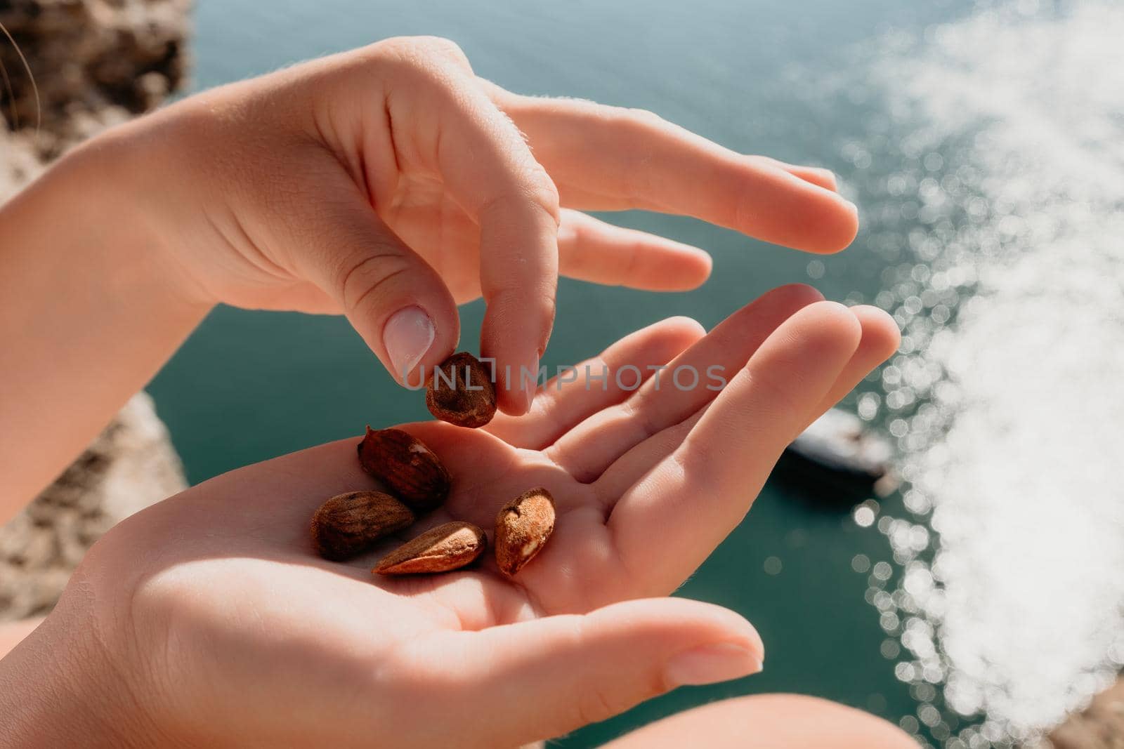 Unrecognizable caucasian woman eating young milky almond nuts. Healthy vegan food