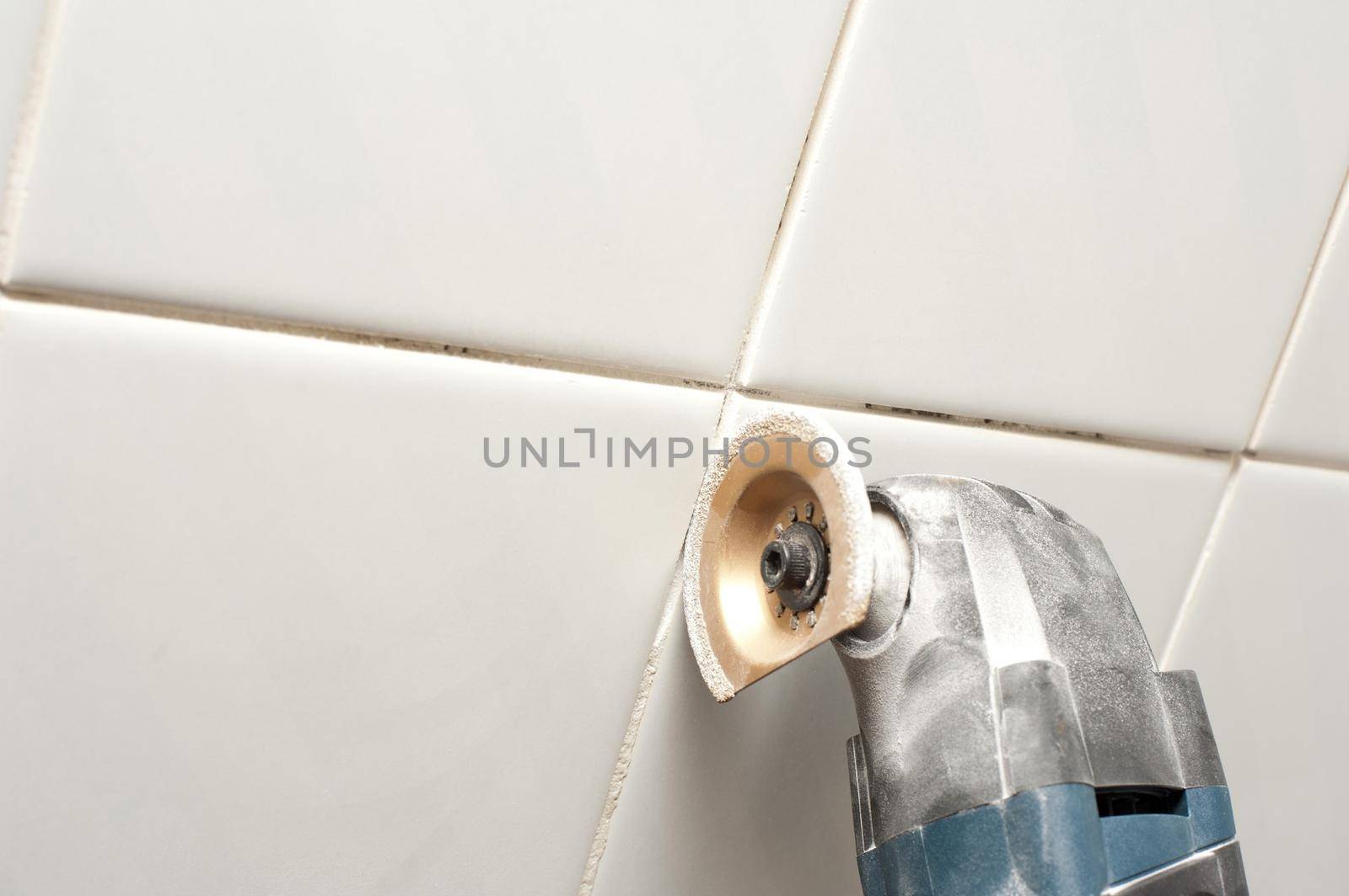 removing grout between bathroom towles with an oscillating type tool