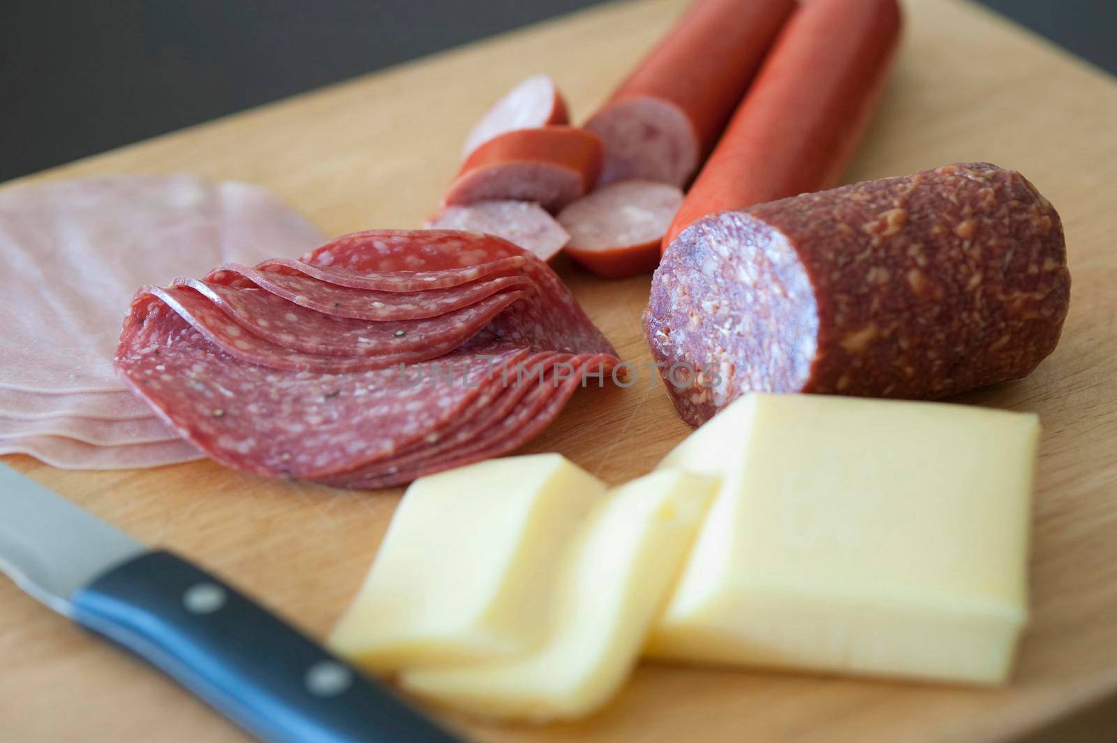 Wholesome German breakfast for a good start to the day with sliced cheese, salami and ham on a chopping board