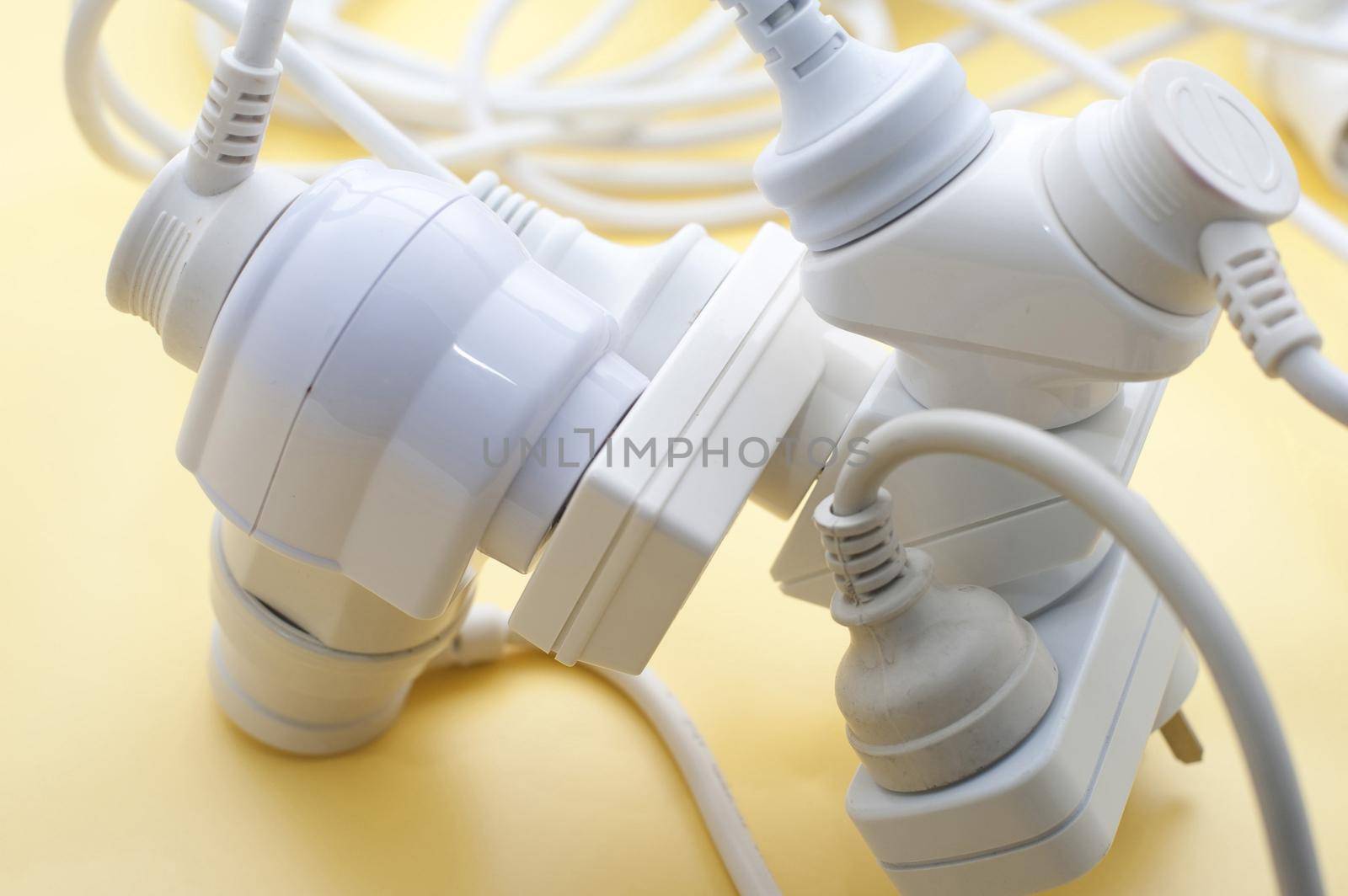 an tangle of mains power adaptors and double plugs