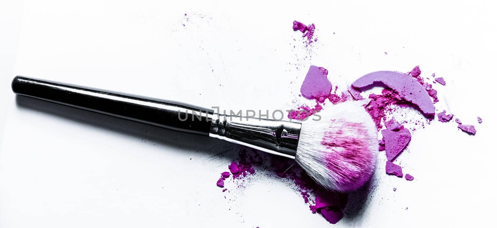 Beauty texture, cosmetic product and art of make-up concept - Brush with crushed eyeshadow and powder close-up isolated on white background