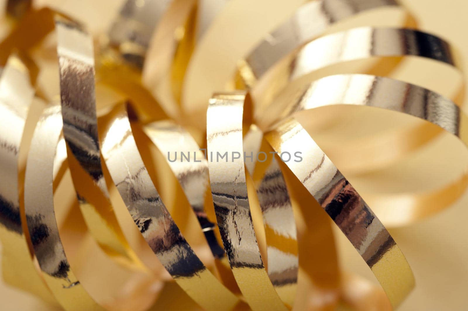 Close Up Still Life of Shiny Gold Ribbon Curl, Macro Shot of Decorative Metallic Wrapping Supplies