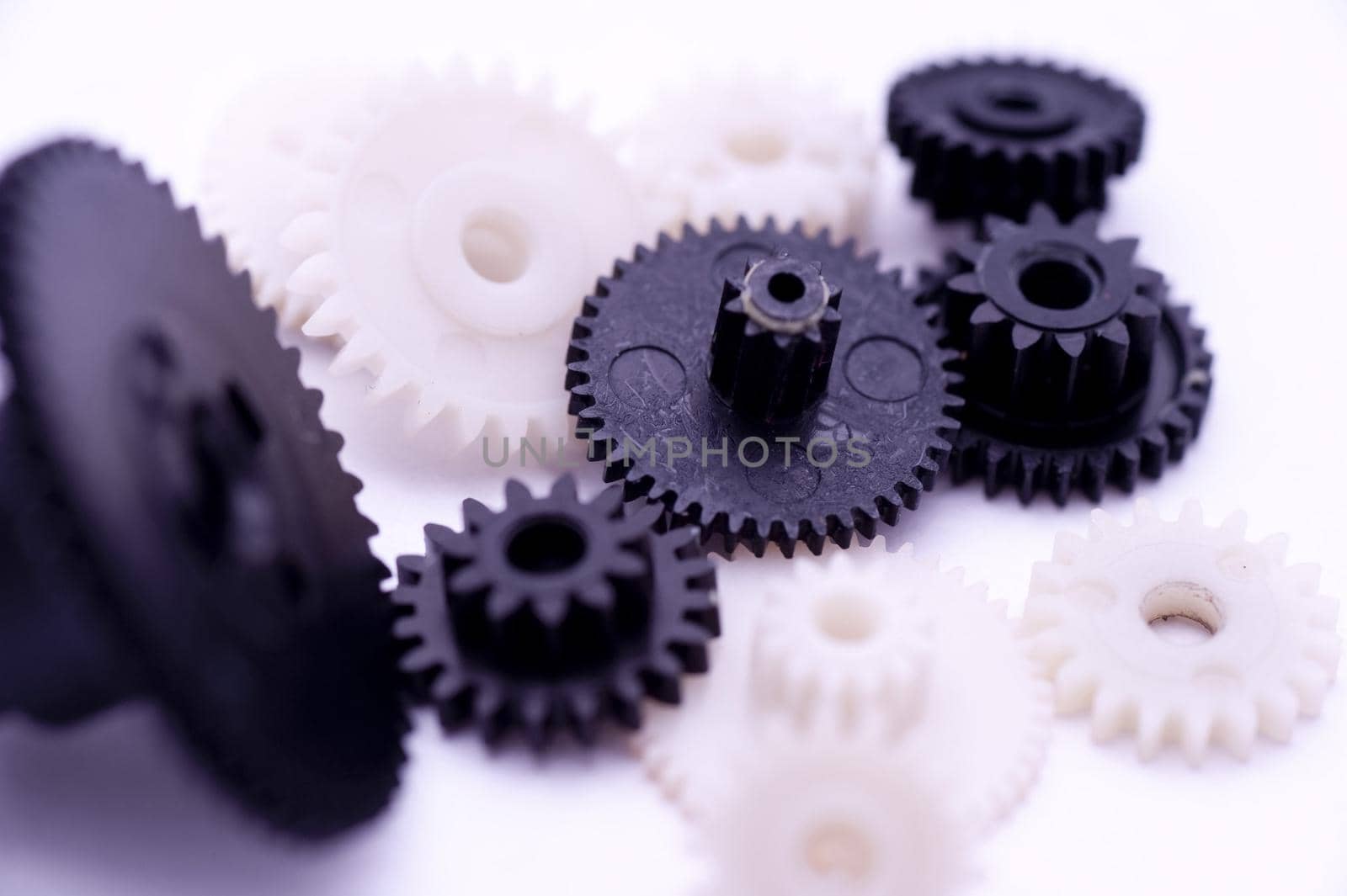 Team Work Concept - Close up Black and White Gears on White Background.
