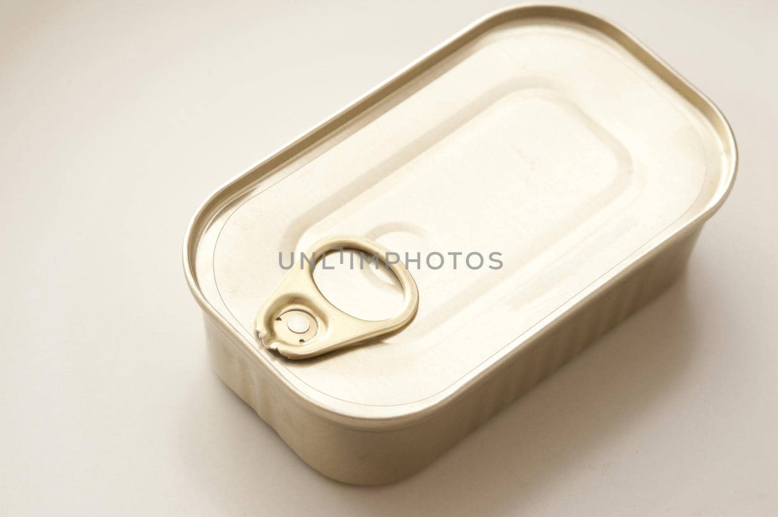 Single sealed metal food can for sardines with blank surface for copy over white background